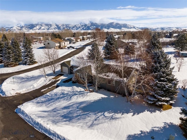 snowy aerial view with a mountain view