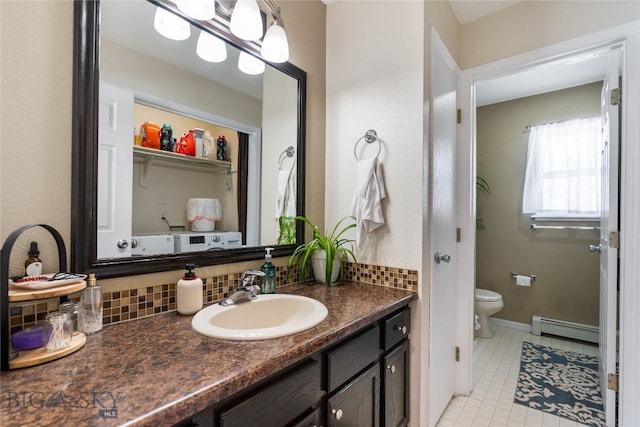 bathroom featuring a baseboard radiator, toilet, backsplash, and vanity