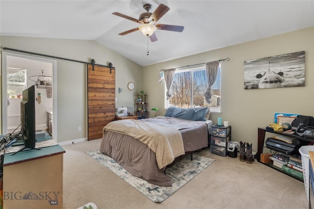 bedroom featuring carpet floors, a barn door, a ceiling fan, vaulted ceiling, and baseboards