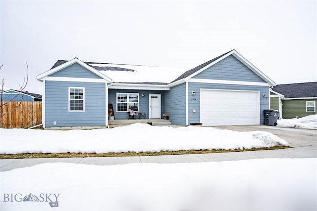 ranch-style house featuring a garage and fence