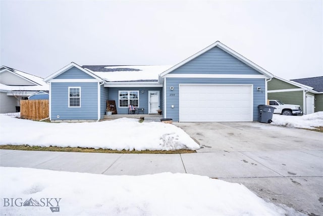 ranch-style house with driveway, an attached garage, and fence