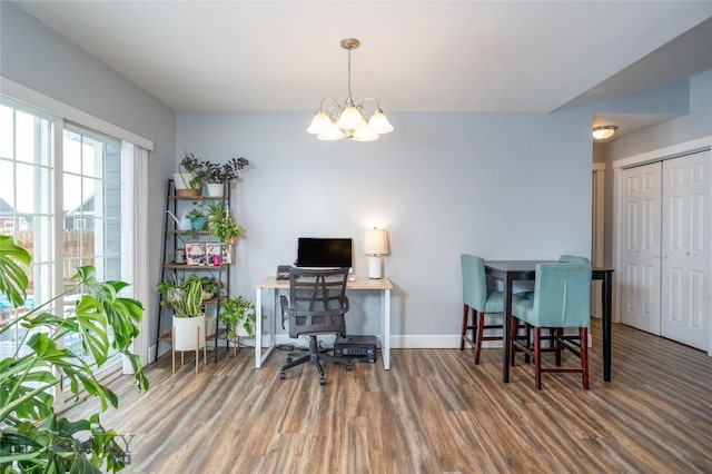 home office with a notable chandelier, baseboards, and wood finished floors