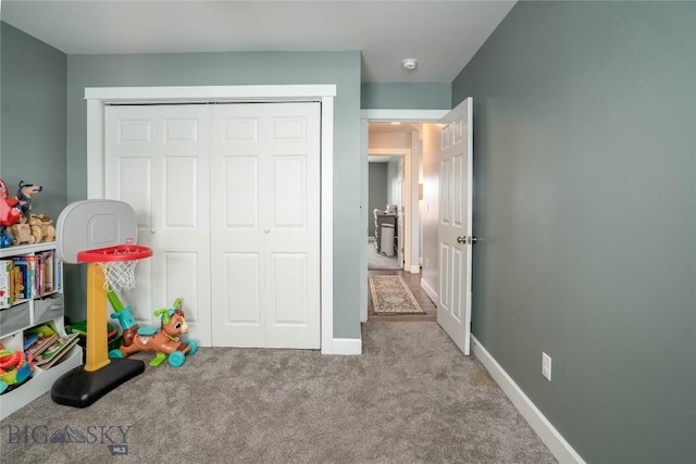 rec room featuring carpet and baseboards