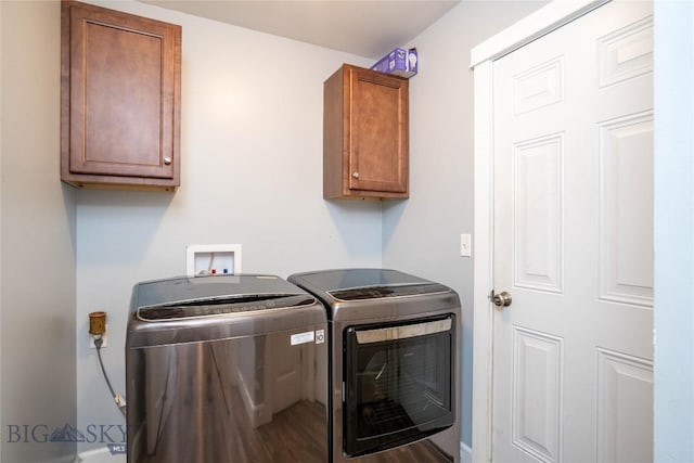 washroom featuring washing machine and clothes dryer and cabinet space