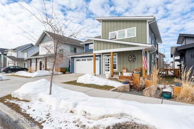 contemporary home with driveway, covered porch, an attached garage, and board and batten siding