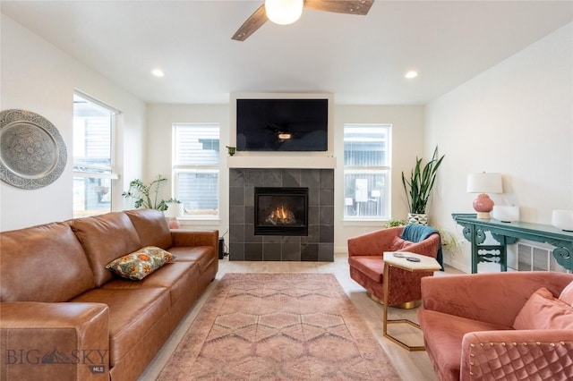 living area with a fireplace, a wealth of natural light, and recessed lighting