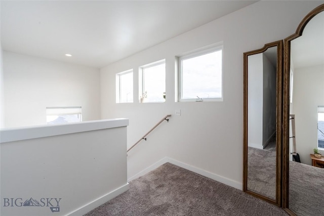 hallway with recessed lighting, baseboards, carpet flooring, and an upstairs landing