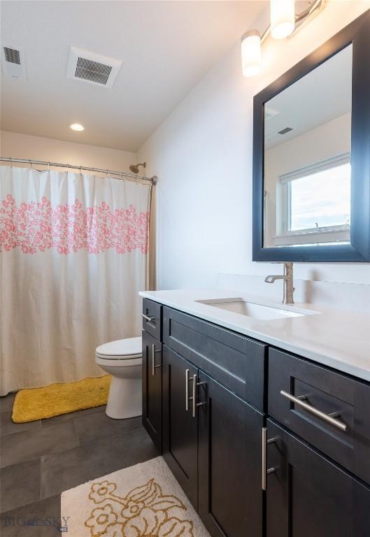 full bath featuring toilet, visible vents, and vanity