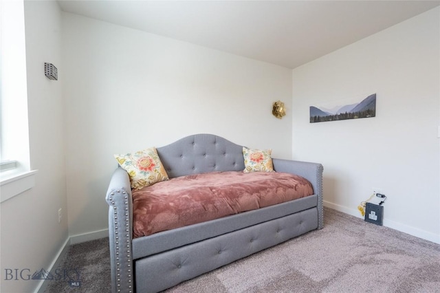 carpeted bedroom featuring baseboards