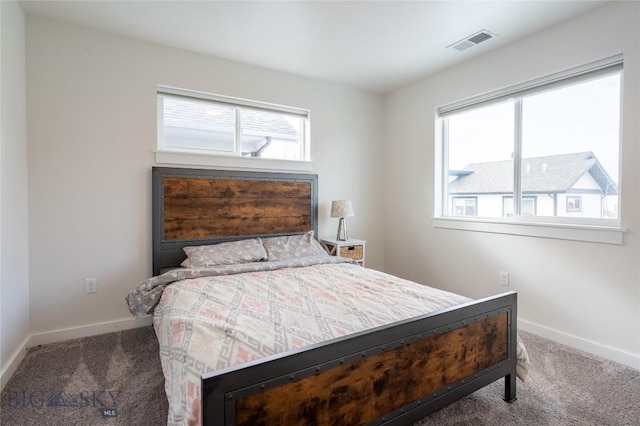 carpeted bedroom featuring visible vents and baseboards