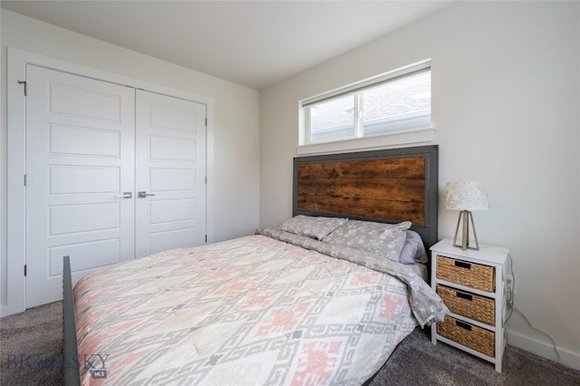 carpeted bedroom with a closet and baseboards