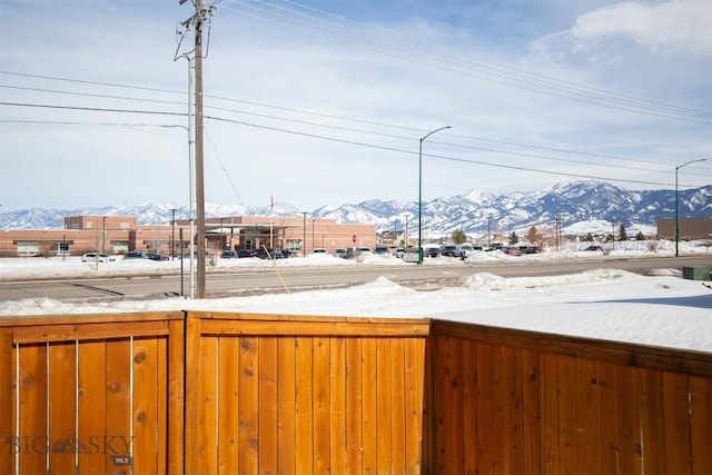 snowy yard with a mountain view