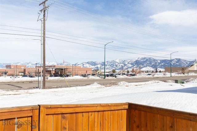 snowy yard with a mountain view