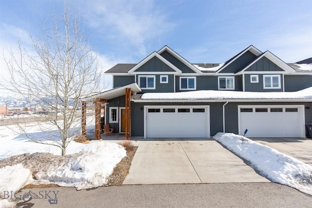 view of front of property featuring driveway, an attached garage, and board and batten siding