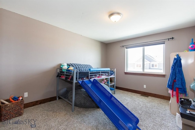 bedroom featuring baseboards and carpet flooring