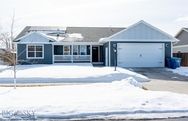 single story home featuring covered porch, solar panels, board and batten siding, and an attached garage