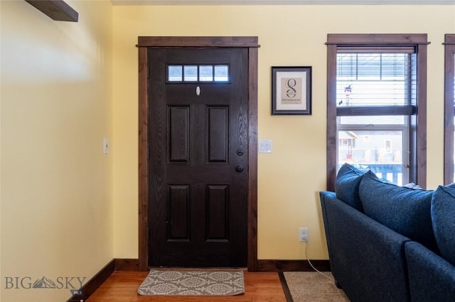 foyer entrance featuring wood finished floors and baseboards