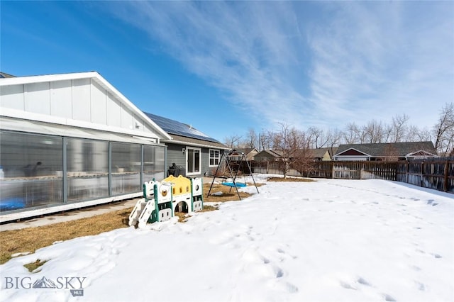 snowy yard with an exterior structure, an outdoor structure, and a fenced backyard