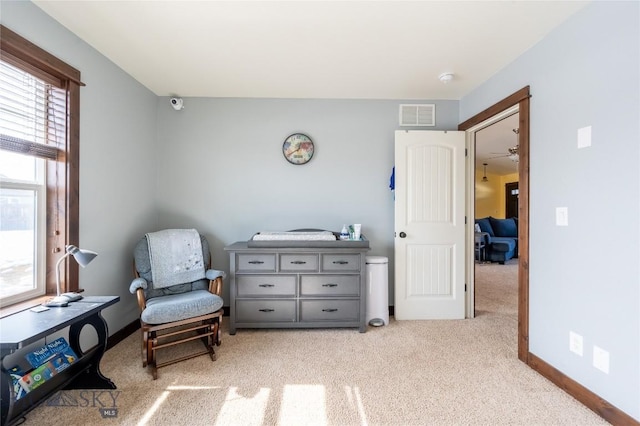 sitting room with baseboards, visible vents, and carpet flooring