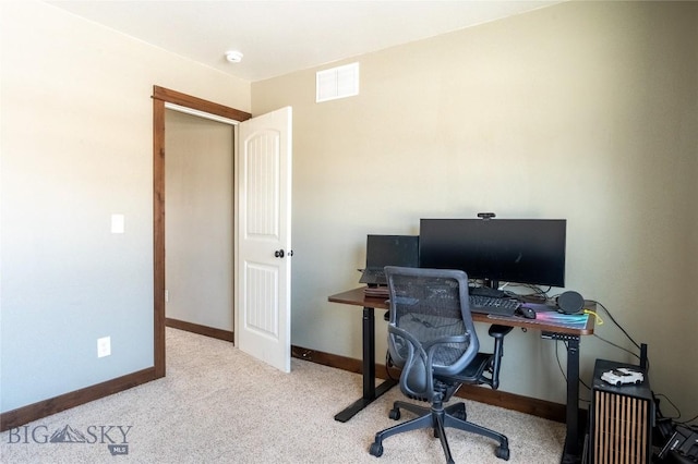 carpeted home office featuring visible vents and baseboards