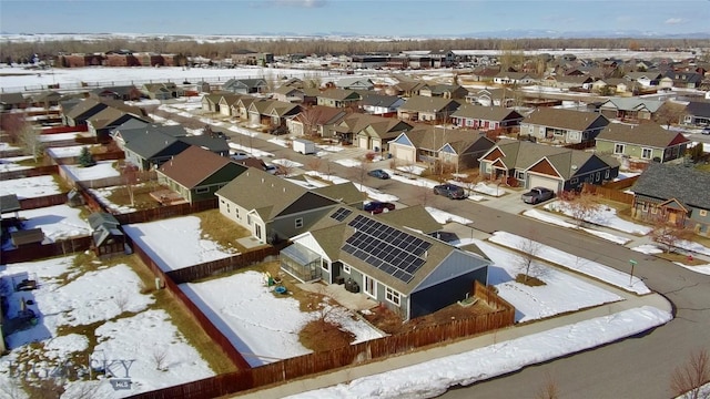 snowy aerial view with a residential view