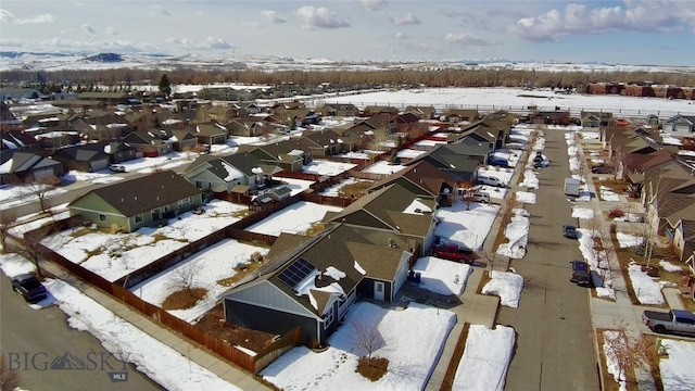 snowy aerial view featuring a residential view