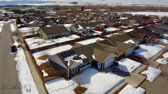 snowy aerial view with a residential view