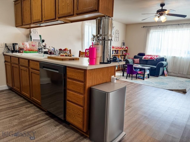 kitchen with dark wood-style floors, brown cabinetry, and dishwasher