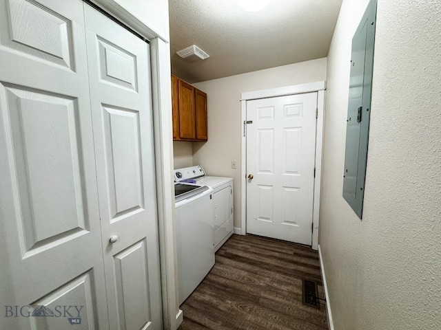 clothes washing area featuring cabinet space, visible vents, washer and clothes dryer, and dark wood-style flooring