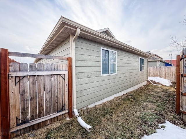 view of home's exterior with fence