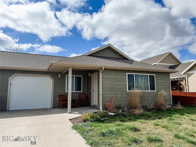 ranch-style home with fence, a shingled roof, an attached garage, driveway, and a front yard