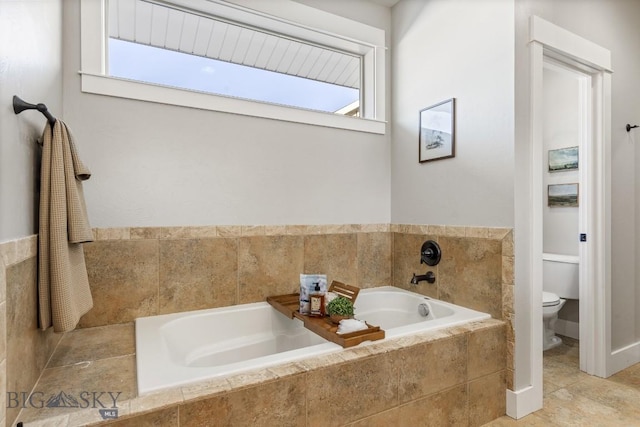 bathroom featuring a garden tub and toilet