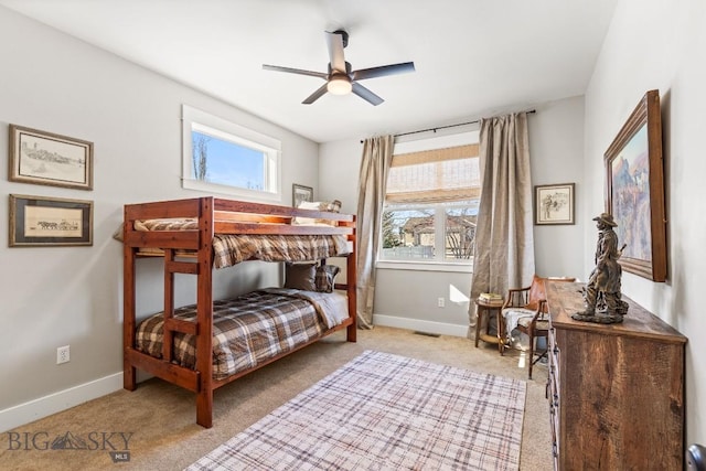 bedroom with carpet floors, multiple windows, and baseboards