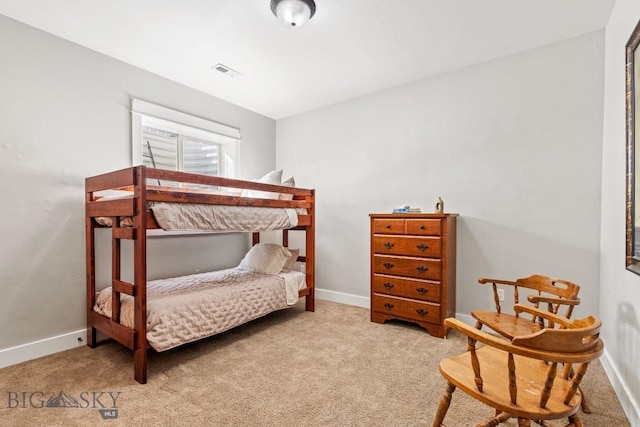 carpeted bedroom with baseboards and visible vents