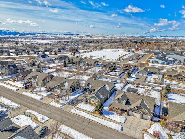 snowy aerial view featuring a residential view