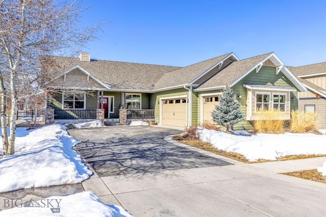 craftsman-style house with driveway, a porch, a chimney, and an attached garage