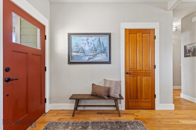 entryway with baseboards and light wood-style floors