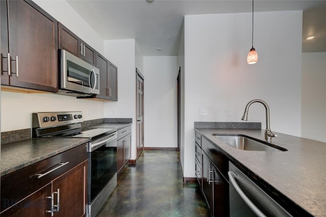 kitchen with decorative light fixtures, stainless steel appliances, a sink, dark brown cabinets, and baseboards