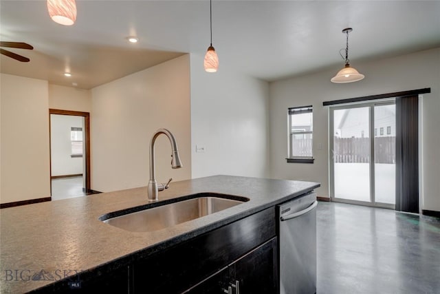 kitchen featuring hanging light fixtures, dishwasher, dark cabinetry, and a sink