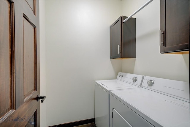 clothes washing area featuring cabinet space and washer and dryer