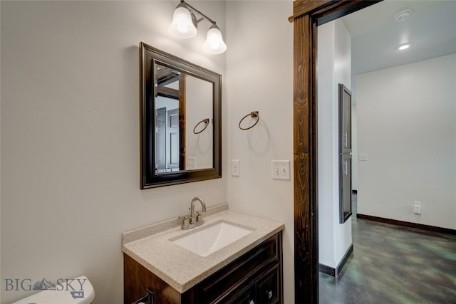 half bath with finished concrete floors, toilet, vanity, and baseboards