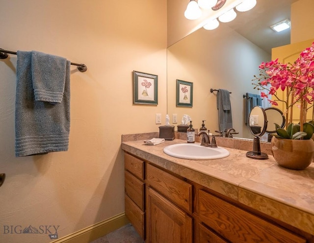 bathroom with vanity and baseboards