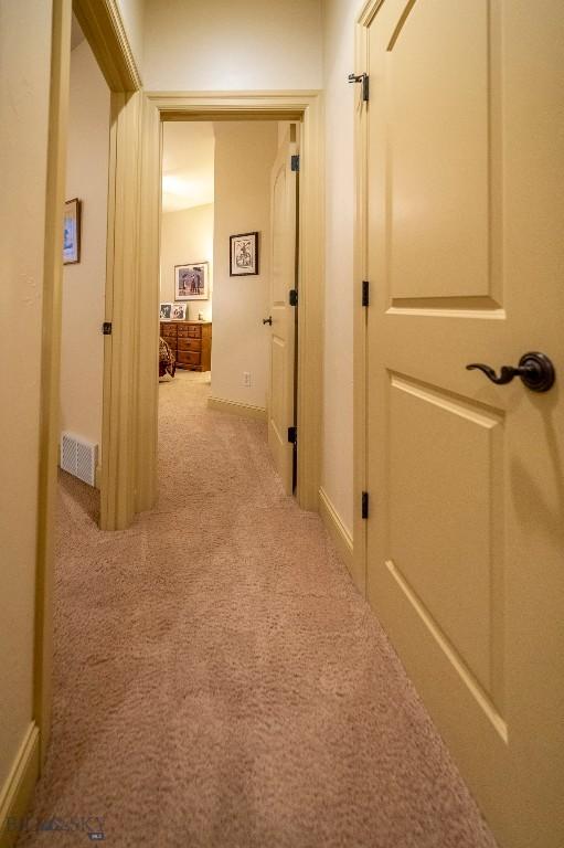 hallway with visible vents and carpet flooring