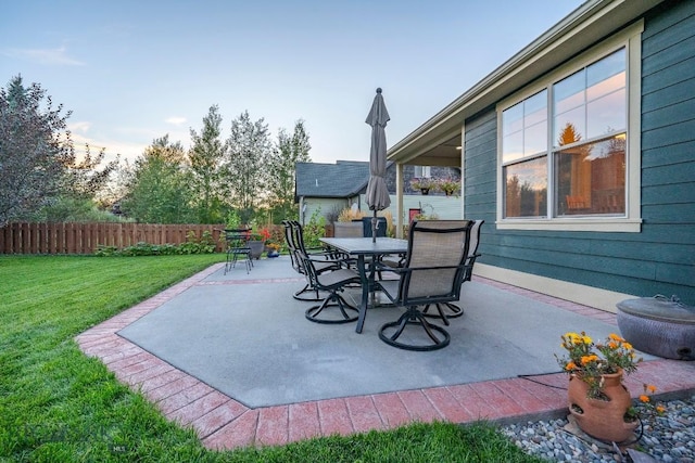 view of patio with outdoor dining area and fence