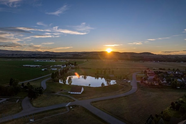 birds eye view of property with a water and mountain view