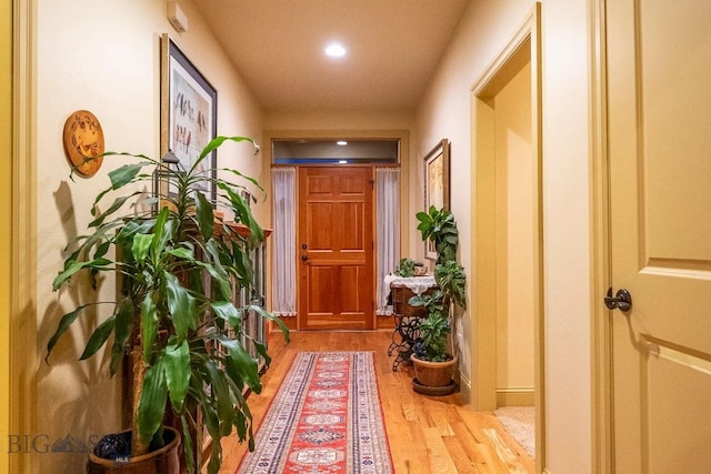 hall with wood finished floors and recessed lighting