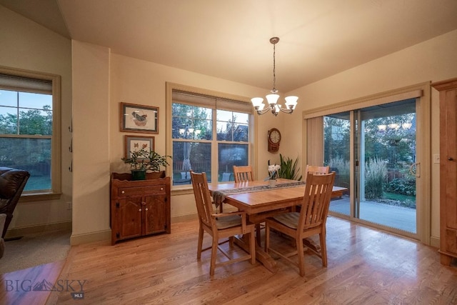 dining room with an inviting chandelier, light wood-style flooring, and a wealth of natural light