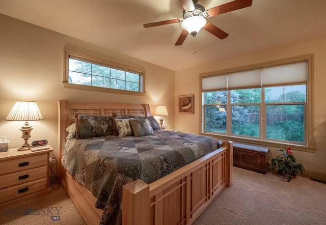 bedroom with light carpet and ceiling fan