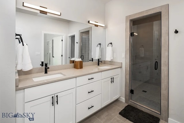 full bathroom with a sink, a stall shower, and tile patterned floors