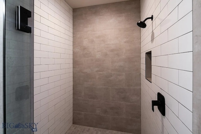 bathroom with tiled shower